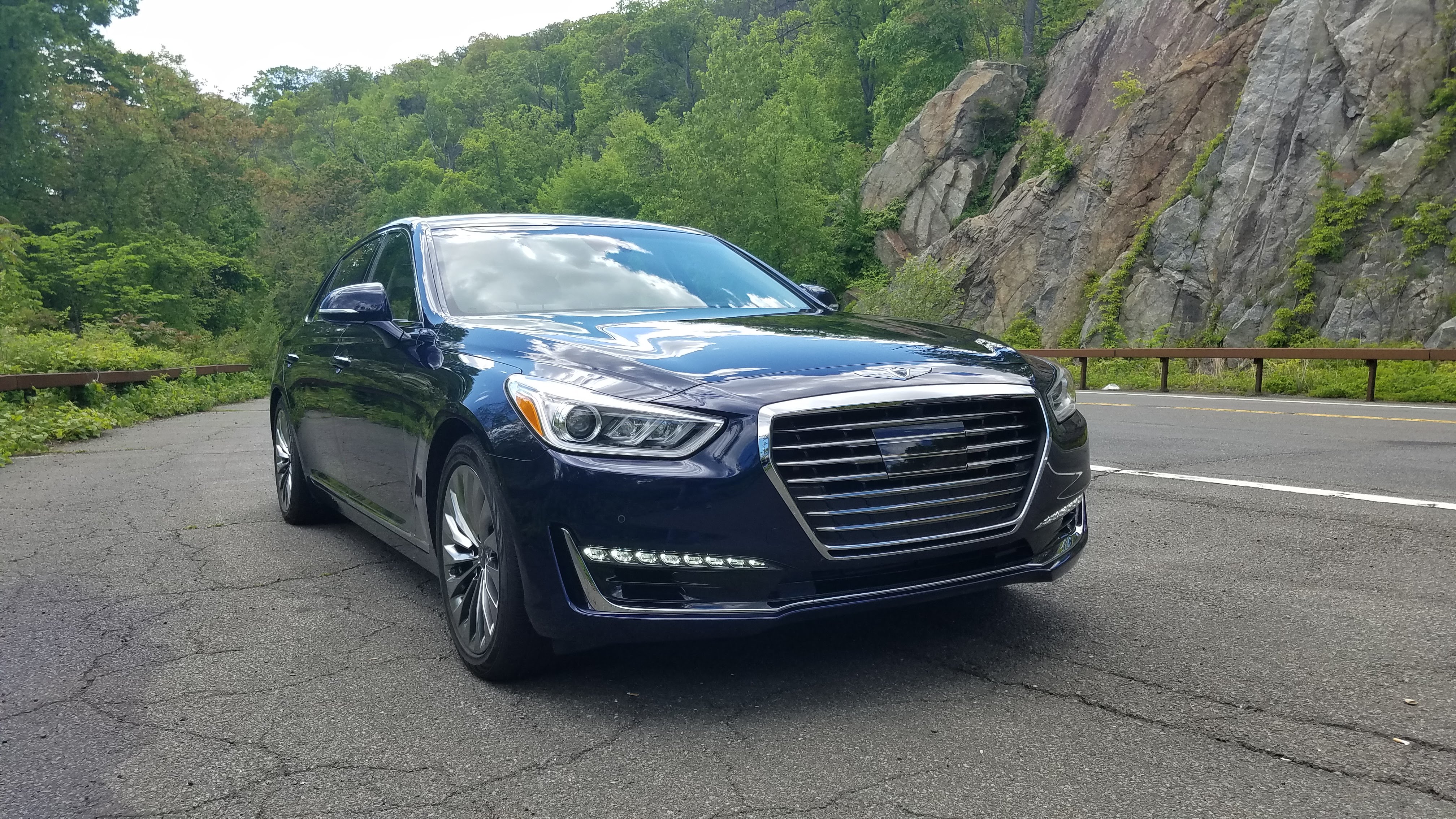 Genesis G90 Parked in front of a rock face
